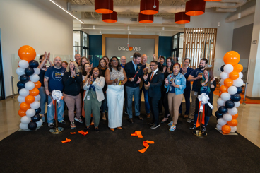 Discover team members celebrate surrounded by balloons.