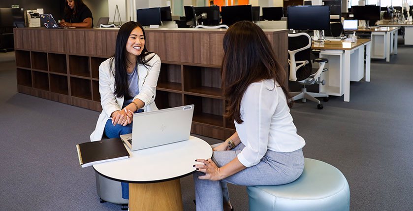 Two Colleagues sitting with a laptop having a chat