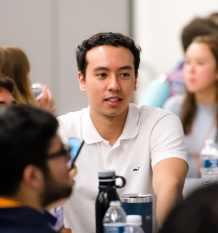 young man amidst a group of other people