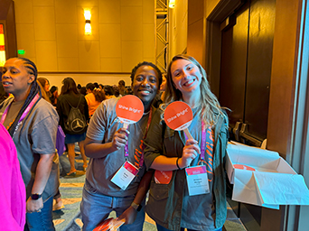 Discover coworkers Holding Signs at event